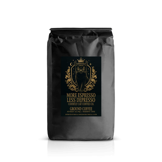 Sophisticated coffee bag with a black label featuring a crowned black cat in in celestial royal crest design with a gold and black background